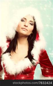 beautiful sexy girl wearing santa claus clothes blue winter snow background
