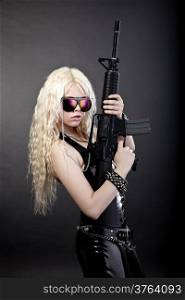 Beautiful sexy girl with a rifle isolated on black background