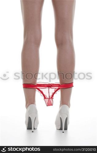 Beautiful Sexy Legs in black high heels and underwear over white background