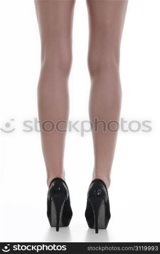 Beautiful Sexy Legs in black high heels over white background