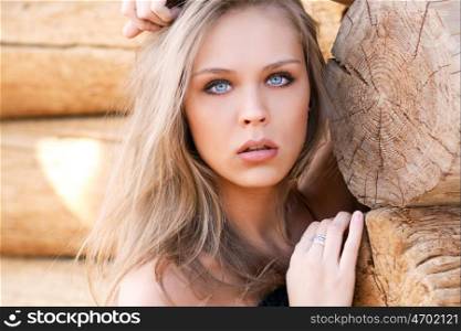 Beautiful sexy model on the background of wooden wall