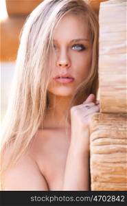 Beautiful sexy model on the background of wooden wall