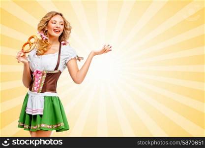 Beautiful sexy Oktoberfest woman wearing a traditional Bavarian dress dirndl posing with a soft salty pretzel on colorful abstract cartoon style background.