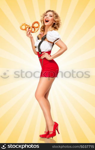 Beautiful sexy Oktoberfest woman wearing red jumper shorts with suspenders in a form of a traditional dirndl, holding two pretzels on colorful abstract cartoon style background.