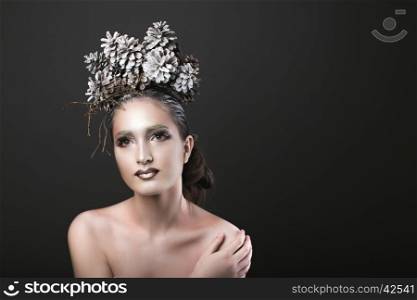 Beautiful Sexy Slim Elegant Girl with Bright Makeup in the New Year Wreath of Christmas Tree and Pine Cones. Elegant Girl in the New Year Wreath of Pine Cones