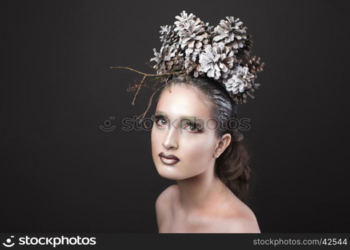 Beautiful Sexy Slim Elegant Girl with Bright Makeup in the New Year Wreath of Christmas Tree and Pine Cones. Elegant Girl in the New Year Wreath of Pine Cones