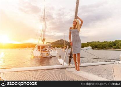 beautiful sexy woman in dress relaxing on a yacht front at sunset. Croatia. beautiful sexy woman in dress relaxing on a yacht front at sunset