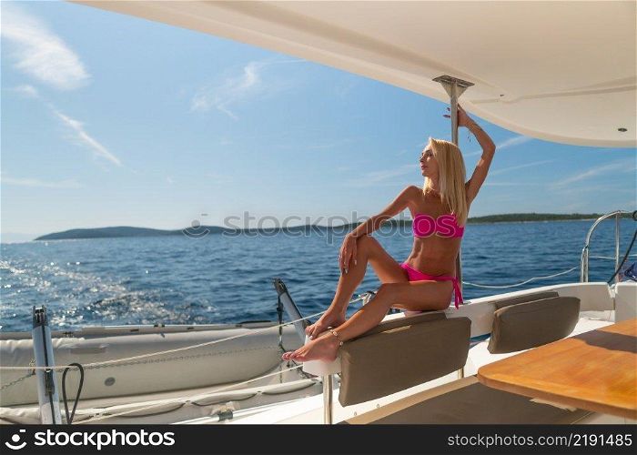 beautiful sexy woman in swimwear relaxing on a yacht at hot summer day. beautiful sexy woman in swimwear relaxing on a yacht
