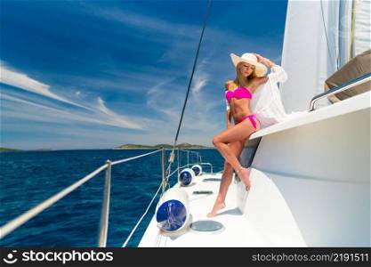 beautiful sexy woman in swimwear relaxing on a yacht at hot summer day. beautiful sexy woman in swimwear relaxing on a yacht