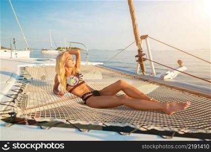 beautiful sexy woman in swimwear relaxing on a yacht front at hot summer day. beautiful sexy woman in swimwear relaxing on a yacht front
