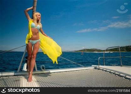 beautiful sexy woman in swimwear relaxing on a yacht front at hot summer day. beautiful sexy woman in swimwear relaxing on a yacht front