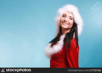 Beautiful sexy woman wearing santa claus costume clothes on blue background