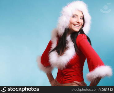 Beautiful sexy woman wearing santa claus costume clothes on blue background