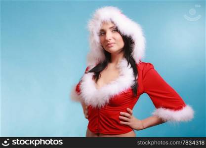 Beautiful sexy woman wearing santa claus costume clothes on blue background
