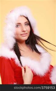Beautiful sexy woman wearing santa claus costume clothes on yellow background