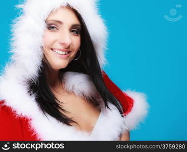 Beautiful sexy woman wearing santa clause costume clothes on blue background