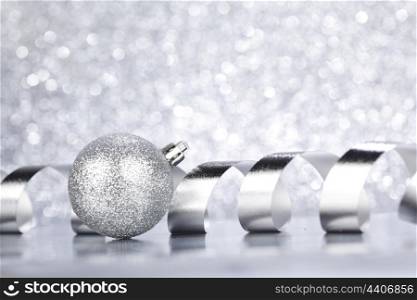 Beautiful shiny Christmas ball decoration on silver background