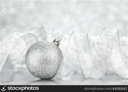 Beautiful shiny Christmas ball decoration on silver background