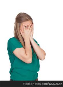 Beautiful shy girl with green t-shirt covering her face isolated on white background