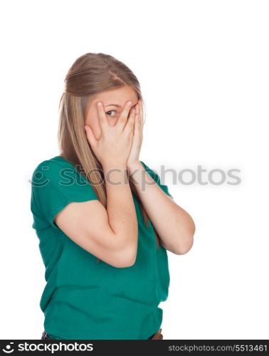 Beautiful shy girl with green t-shirt covering her face isolated on white background