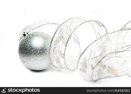 Beautiful silvery New Year&rsquo;s ball and decorative tape on a white background
