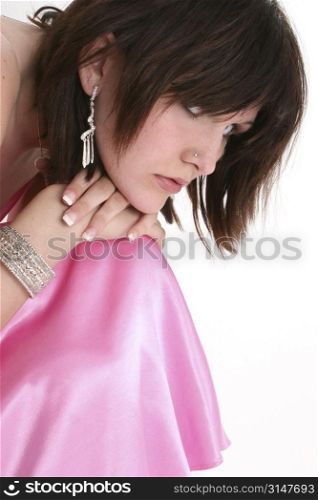 Beautiful sixteen year old girl in pink formal or prom dress. Dark hair and blue eyes.