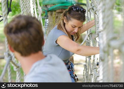 beautiful skilled woman in a rope course