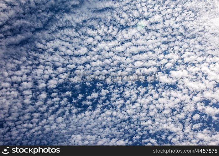 Beautiful sky background, many white little fluffy clouds over blue sky backdrop, abstract natural wallpaper, good summer weather
