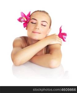 Beautiful sleeping woman in spa salon, pretty female face with pink orchid flower, cute girl isolated on white background, young lady relaxing on massage table, beauty treatment and health care