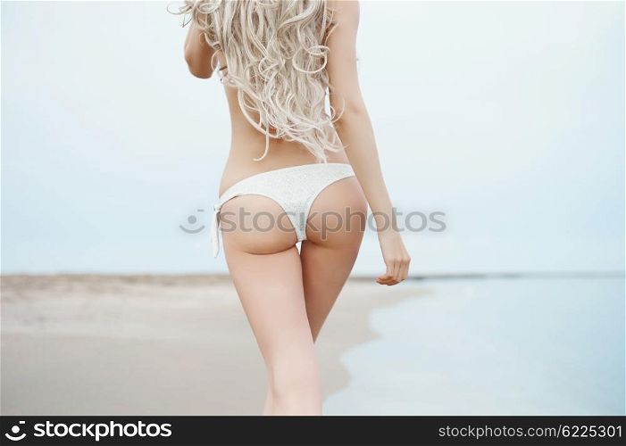 Beautiful slender blonde at the sea. Summer travel photos