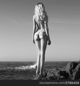 Beautiful slender blonde on sea. Summer travel photos