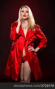 Beautiful slender blonde woman in a red raincoat