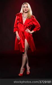 Beautiful slender blonde woman in a red raincoat