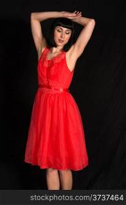 Beautiful slender brunette in a red dress