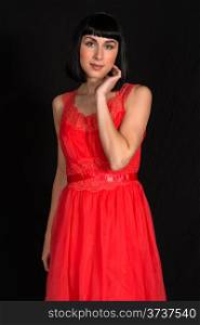 Beautiful slender brunette in a red dress