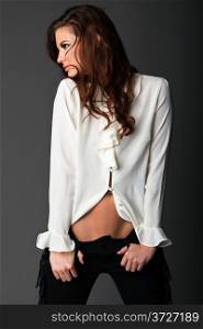 Beautiful slender brunette in a white blouse and black pants