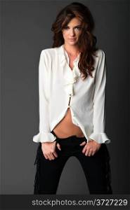 Beautiful slender brunette in a white blouse and black pants