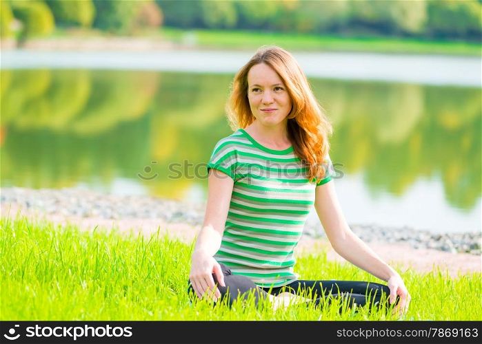 beautiful slender girl is preparing for yoga on the nature
