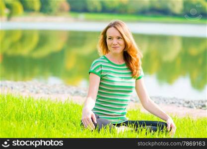 beautiful slender girl is preparing for yoga on the nature