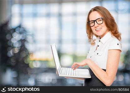 beautiful slim secretary with a laptop in the office