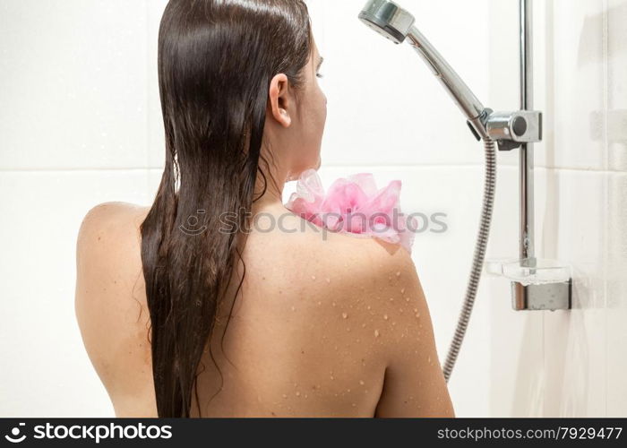 Beautiful slim woman washing in shower