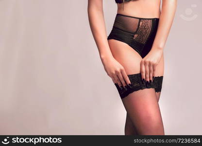 Beautiful, slim woman wear her alluring underwear.Sexy lady in elegant black bra.Fashion portrait isolated background.. Beautiful, slim woman posing in alluring underwear