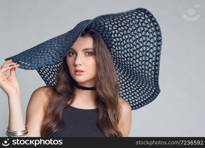 Beautiful, slim woman with big and large summer hat in alluring underwear.Sexy lady in lingerie.Fashion portrait of model indoors.. Beautiful, slim woman posing with big hat