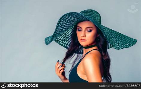 Beautiful, slim woman with big and large summer hat in alluring underwear.Sexy lady in lingerie.Fashion portrait of model indoors.. Beautiful, slim woman posing with big hat