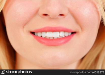 Beautiful smile of blonde girl with white teeths