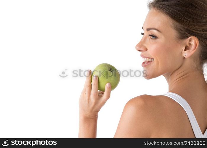 Beautiful smile, white strong teeth. Head and shoulders of young woman with snow-white toothy smile holding green apple, teethcare. Studio isolated on white background. Woman with holding green apple