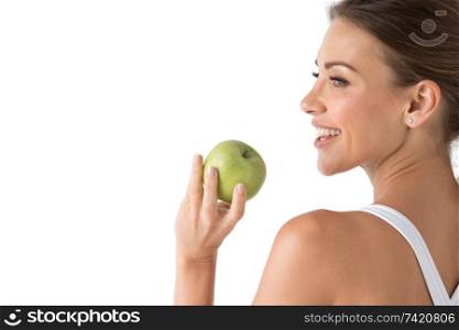 Beautiful smile, white strong teeth. Head and shoulders of young woman with snow-white toothy smile holding green apple, teethcare. Studio isolated on white background. Woman with holding green apple