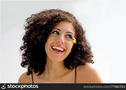 Beautiful smiling brunette with yellow flower and purple eyeshadow, isolated