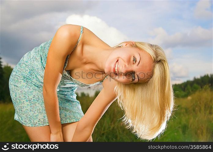 Beautiful smiling girl in the field
