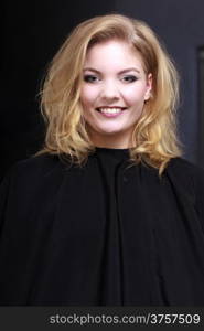 Beautiful smiling girl with blond wavy hair by hairdresser. Happy young woman in hairdressing beauty salon. Hairstyle.